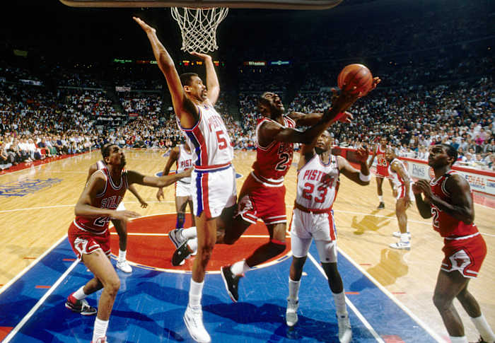 May 1989; Detroit, MI, USA: FILE PHOTO; Chicago Bulls guard Michael Jordan (23) is defended by Detroit Pistons center James Edwards (53) during the 1988-89 NBA Eastern Conference Finals at The Palace.